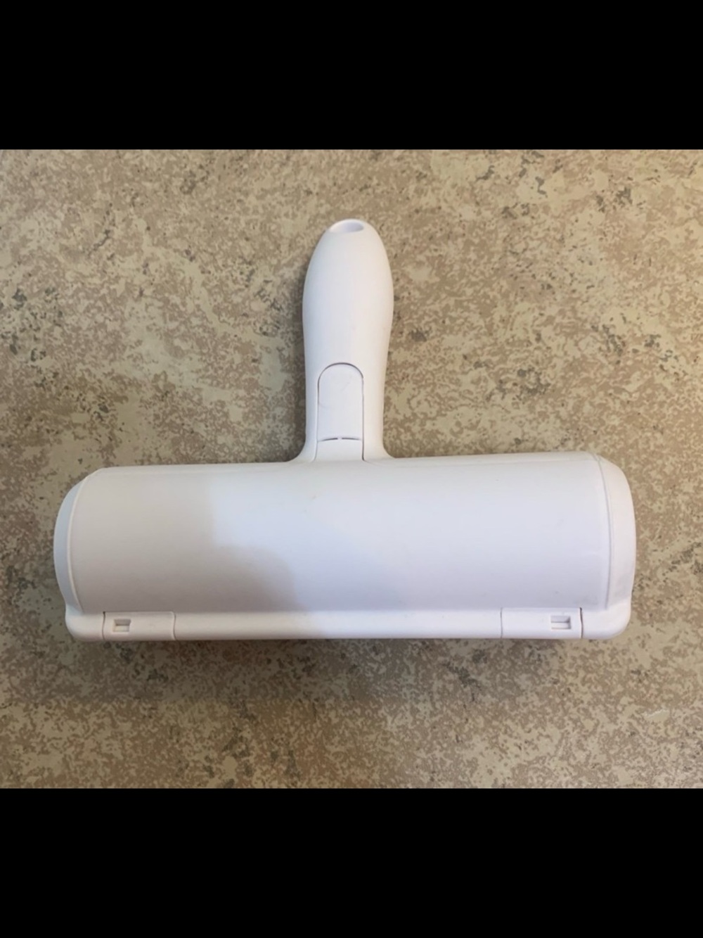 Reusable pet hair remover roller. Works by using a specialized brush to trap fur